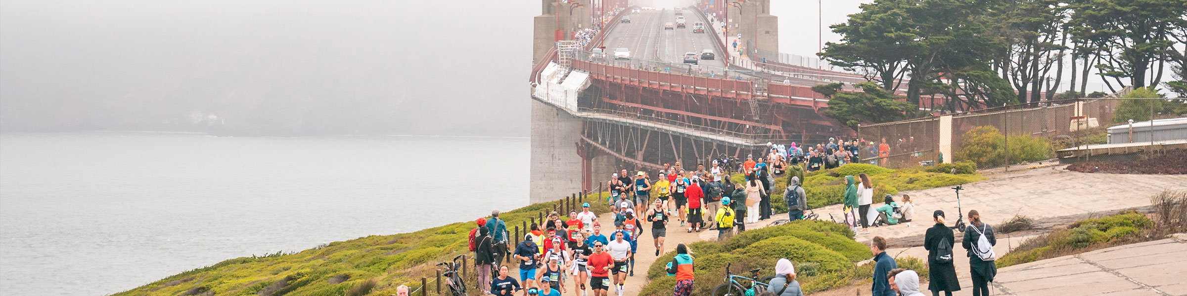 Header for the 2024 San Francisco Marathon Athlete Guide with runners running from the olden Gate Bridge