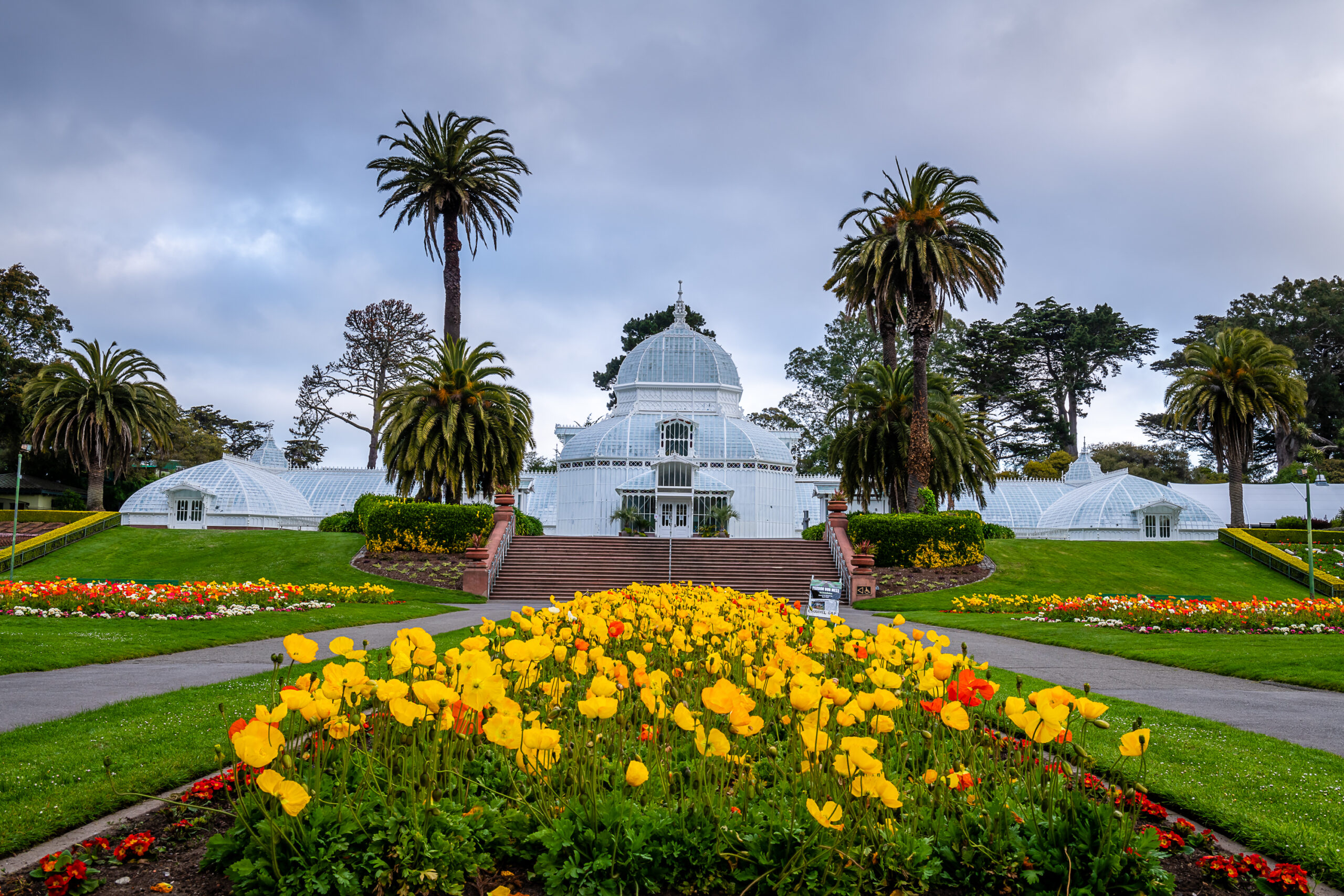 Conservatory of Flowers in Golden Gate Park with yellow tulips in front of the Victorian building