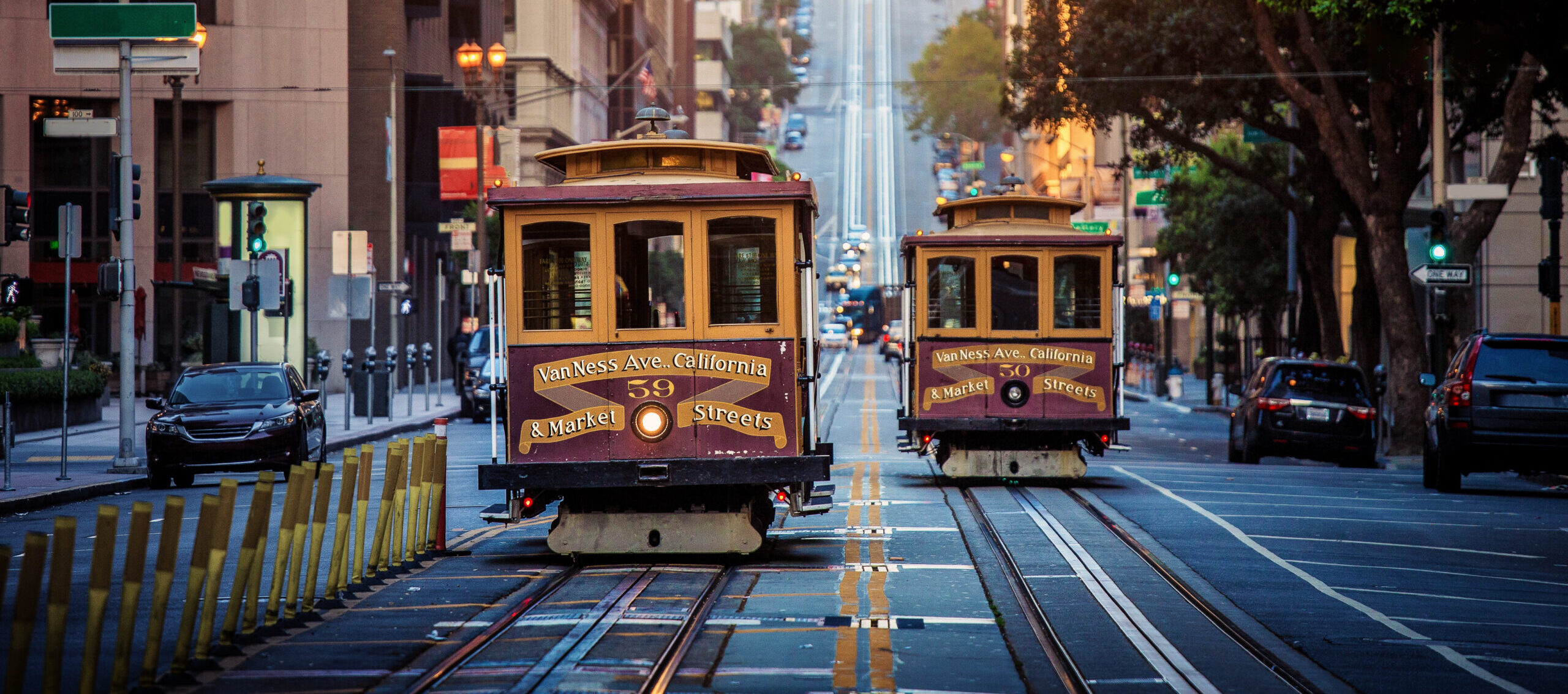 Old-fashioned San Francisco street cars ride around Mission District at sunrise