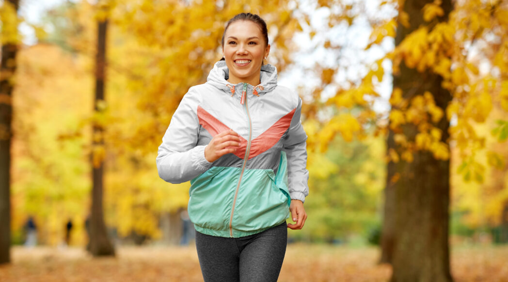 A happy woman is running through autumnal woods, knows how to start running