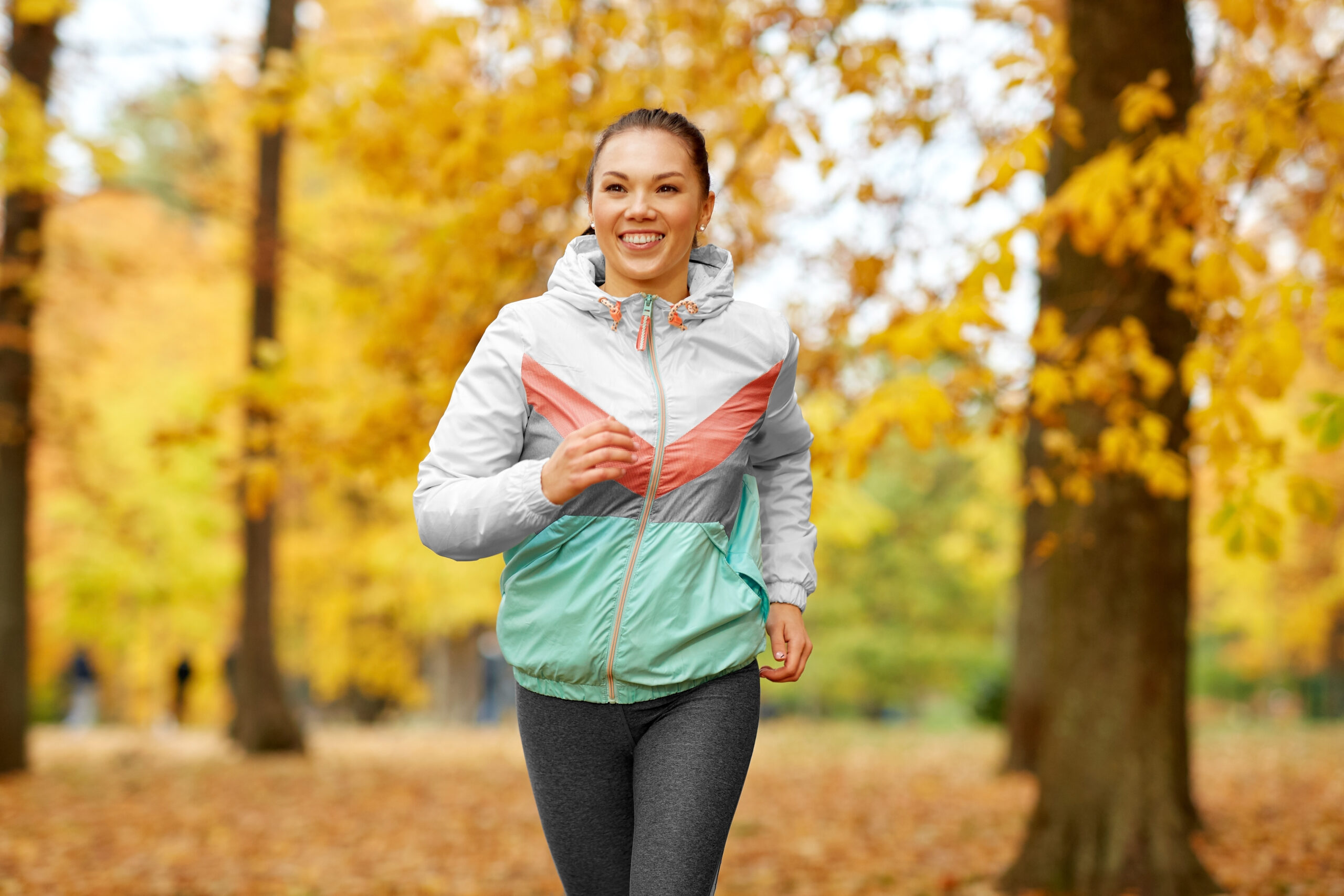 A happy woman is running through autumnal woods, knows how to start running