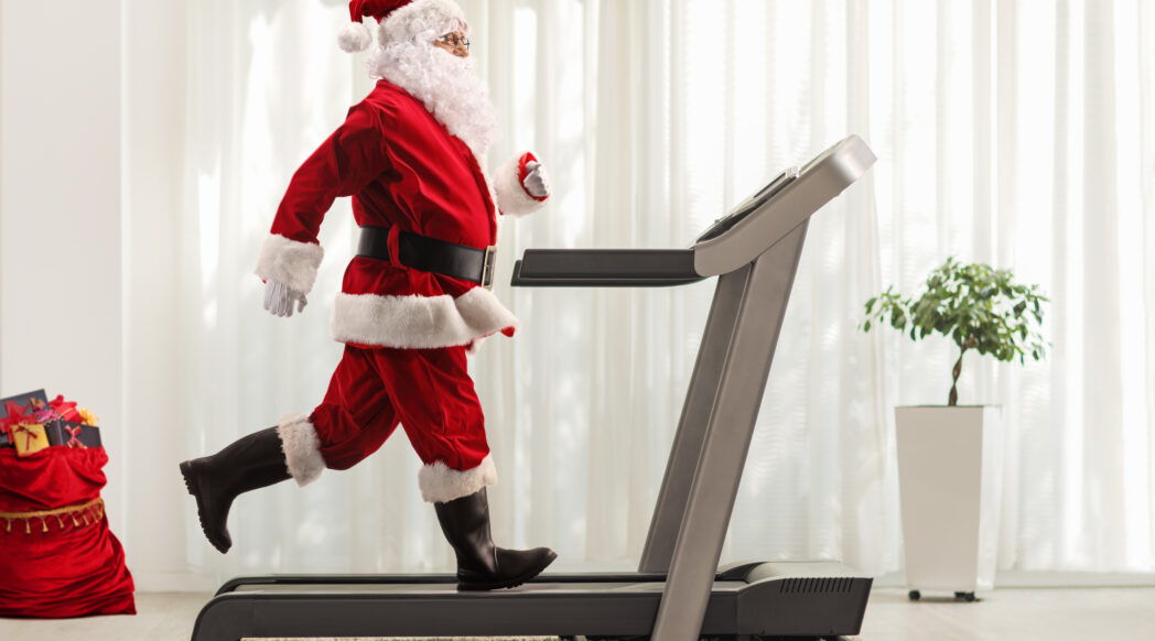 A Santa is running on a treadmill during Christmas. Goals.