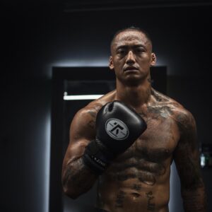 Jeremiah Maestre poses in a martial arts gym, New Year Goals.